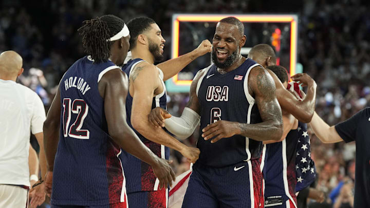 Aug 10, 2024; Paris, France; United States guard LeBron James (6) and small forward Jayson Tatum (10) and guard Jrue Holiday (12) celebrate after defeating France in the men's basketball gold medal game during the Paris 2024 Olympic Summer Games at Accor Arena. Mandatory Credit: Kyle Terada-USA TODAY Sports