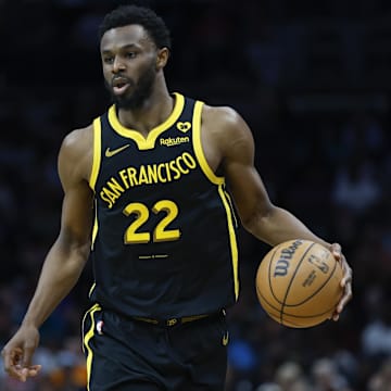 Mar 29, 2024; Charlotte, North Carolina, USA; Golden State Warriors forward Andrew Wiggins (22) brings the ball up court against the Charlotte Hornets during the second half at Spectrum Center. Mandatory Credit: Nell Redmond-Imagn Images