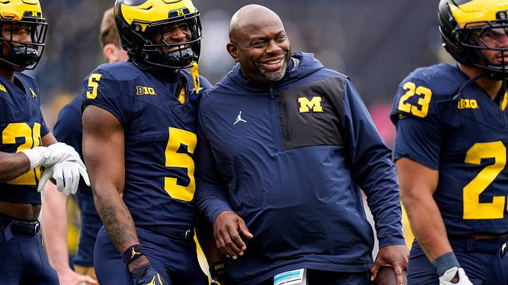 Michigan running backs coach Tony Alford, center, talks to running back Savion Hiter (5) before the spring game at Michigan Stadium in Ann Arbor on Saturday, April 18, 2026.
