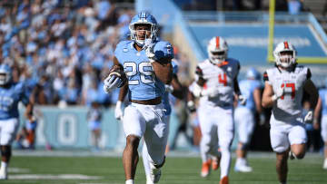 Nov 4, 2023; Chapel Hill, North Carolina, USA; North Carolina Tar Heels running back Omarion Hampton (28) runs as Campbell Fighting Camels linebacker Monchovia Gaffney (4) and linebacker Taylor Behl (17) defend in the first quarter at Kenan Memorial Stadium. Mandatory Credit: Bob Donnan-USA TODAY Sports