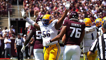 Sep 7, 2024; College Station, Texas, USA; McNeese State Cowboys defensive lineman Stephen Johnson (56) celebrates a play near Texas A&M Aggies offensive lineman Reuben Fatheree II (76) during the first quarter at Kyle Field. Mandatory Credit: Dustin Safranek-Imagn Images