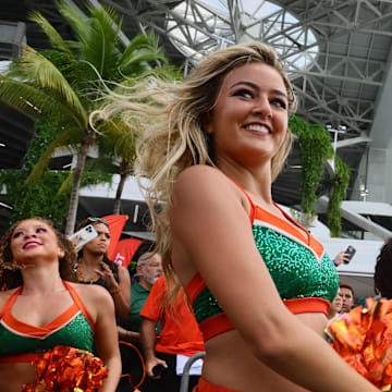 Sep 14, 2024; Miami Gardens, Florida, USA; A Miami Hurricanes cheerleader performs as the team arrives at Hard Rock Stadium before a game against the Ball State Cardinals. Mandatory Credit: Sam Navarro-Imagn Images