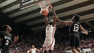 Feb 25, 2025; Tuscaloosa, AL, USA;  Alabama center Clifford Omoruyi (11) gets a put back dunk between Mississippi State forward Keshawn Murphy (3) and Mississippi State guard Josh Hubbard (12) at Coleman Coliseum.