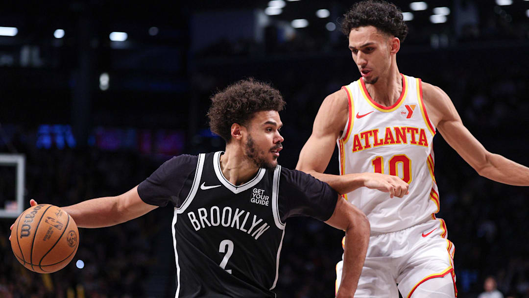 Mar 16, 2025; Brooklyn, New York, USA; Brooklyn Nets forward Cameron Johnson (2) is defended by Atlanta Hawks forward Zaccharie Risacher (10) during the second half at Barclays Center. Mandatory Credit: Vincent Carchietta-Imagn Images
