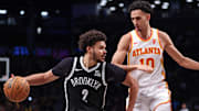 Mar 16, 2025; Brooklyn, New York, USA; Brooklyn Nets forward Cameron Johnson (2) is defended by Atlanta Hawks forward Zaccharie Risacher (10) during the second half at Barclays Center. Mandatory Credit: Vincent Carchietta-Imagn Images