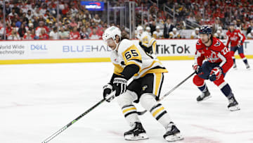 Nov 8, 2024; Washington, District of Columbia, USA; Pittsburgh Penguins defenseman Erik Karlsson (65) skates with the puck as Washington Capitals right wing Brandon Duhaime (22) chases in the third period at Capital One Arena. Mandatory Credit: Geoff Burke-Imagn Images