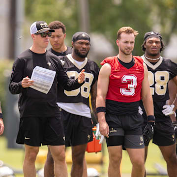 Jun 10, 2025; New Orleans, LA, USA;  New Orleans Saints quarterback Tyler Shough (6) and quarterback Spencer Rattler (2) and quarterback Jake Haener (3) look on during minicamp at Ochsner Sports Performance Center. Mandatory Credit: Stephen Lew-Imagn Images
