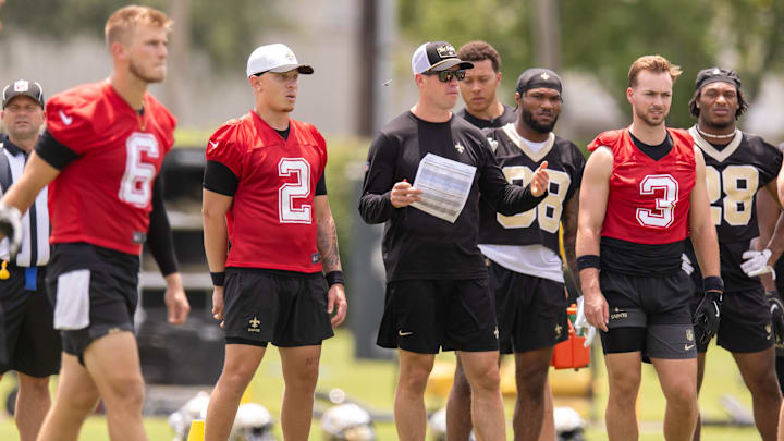 Jun 10, 2025; New Orleans, LA, USA; New Orleans Saints quarterback Tyler Shough (6) and quarterback Spencer Rattler (2) and quarterback Jake Haener (3) look on during minicamp at Ochsner Sports Performance Center. Mandatory Credit: Stephen Lew-Imagn Images Jun 10, 2025; New Orleans, LA, USA; New Orleans Saints quarterback Tyler Shough (6) and quarterback Spencer Rattler (2) and quarterback Jake Haener (3) look on during minicamp at Ochsner Sports Performance Center. Mandatory Credit: Stephen Lew-Imagn Images