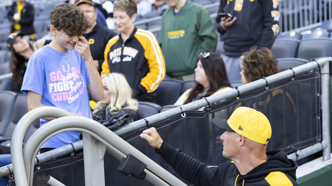 May 9, 2025; Pittsburgh, Pennsylvania, USA; Pittsburgh Pirates manager Don Kelly (12) talks with a fan before the game against the Atlanta Braves at PNC Park. Mandatory Credit: Scott Galvin-Imagn Images
