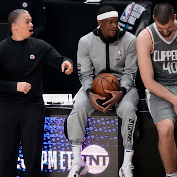 Jun 26, 2021; Los Angeles, California, USA; LA Clippers guard Patrick Beverley (21) and head coach Trronn Lue, and Rajon Rondo and center Ivica Zubac (40) reactsduring the closing seconds of the Clippers loss to the Phoenix Suns in game four of the Western Conference Finals for the 2021 NBA Playoffs at Staples Center. Mandatory Credit: Robert Hanashiro-Imagn Images