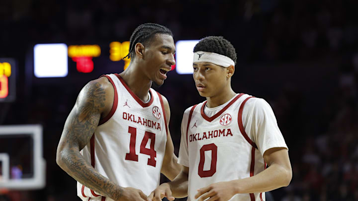 Feb 26, 2025; Norman, Oklahoma, USA; Oklahoma Sooners forward Jalon Moore (14) and guard Jeremiah Fears (0) talk during a break in play against the Kentucky Wildcats during the second half at Lloyd Noble Center. Mandatory Credit: Alonzo Adams-Imagn Images