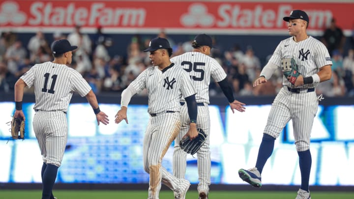 Aug 23, 2024; Bronx, New York, USA; New York Yankees center fielder Aaron Judge (99) and second baseman Gleyber Torres (25) and right fielder Juan Soto (22)  and shortstop Anthony Volpe (11) celebrate after defeating the Colorado Rockies at Yankee Stadium. Mandatory Credit: Vincent Carchietta-USA TODAY Sports