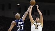 Oct 4, 2025; San Diego, California, USA; Denver Nuggets center Nikola Jokic (15) shoots over Minnesota Timberwolves center Rudy Gobert (27) during the first half at Pechanga Arena. Mandatory Credit: Denis Poroy-Imagn Images