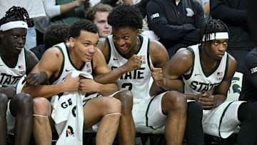 Nov 8, 2025; East Lansing, Michigan, USA;  The Michigan State bench including Michigan State Spartans forward Cameron Ward (3) and Michigan State Spartans guard Divine Ugochukwu (99) celebrate their win over Arkansas at Jack Breslin Student Events Center. Mandatory Credit: Dale Young-Imagn Images