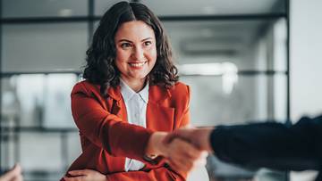 Businesswoman shaking hands with someone at work