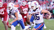 Louisiana Tech Bulldogs kicker Buck Buchanan (15) runs for a first down on a fake field goal during the first quarter against the Arkansas Razorbacks at Razorback Stadium.