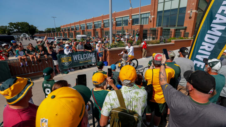 Green Bay Packers kicker James Turner rides a bicycle to practice at training camp on Monday.