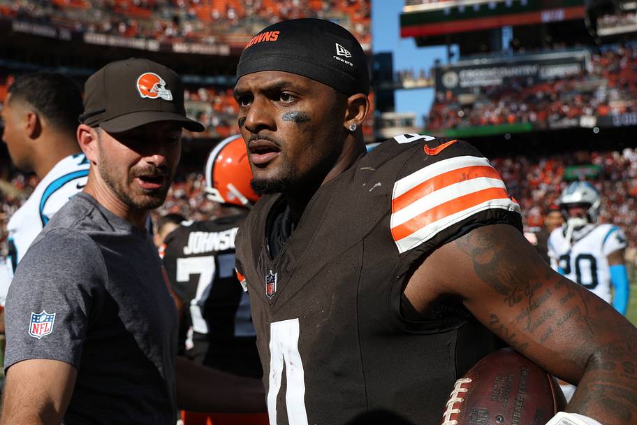 Deshaun Watson holds a ball on the field after a win.