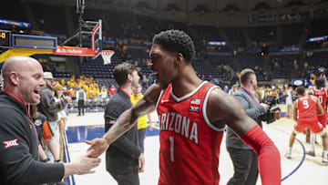 Jan 7, 2025; Morgantown, West Virginia, USA; Arizona Wildcats guard Caleb Love (1) celebrates with coaches after defeating the West Virginia Mountaineers at WVU Coliseum. Mandatory Credit: Ben Queen-Imagn Images