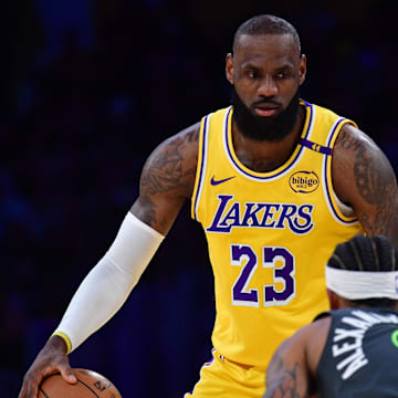 Apr 30, 2025; Los Angeles, California, USA; Los Angeles Lakers forward LeBron James (23) controls the ball against Minnesota Timberwolves guard Nickeil Alexander-Walker (9) during the first half in game five of first round for the 2025 NBA Playoffs at Crypto.com Arena. Mandatory Credit: Gary A. Vasquez-Imagn Images