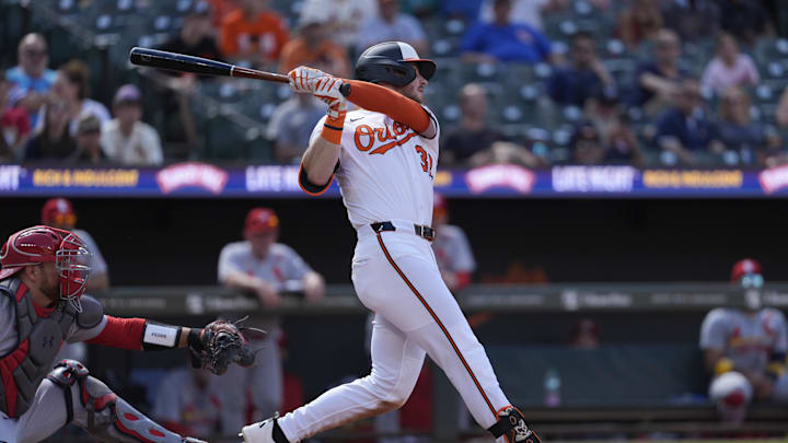 May 26, 2025; Baltimore, Maryland, USA; Baltimore Orioles right fielder Ryan O'Hearn (32) hits a single against the St. Louis Cardinals during the fourth inning at Oriole Park at Camden Yards. 