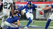 Sep 26, 2024; East Rutherford, New Jersey, USA; New York Giants place kicker Greg Joseph (34) kicks a field goal with punter Jamie Gillan (6) holding during the first quarter against the Dallas Cowboys at MetLife Stadium.  