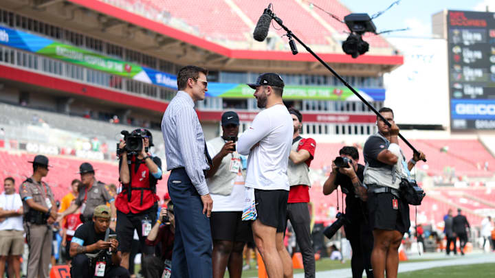 Tom Brady speaks to Tampa Bay Buccaneers quarterback Baker Mayfield before Sunday's game. 