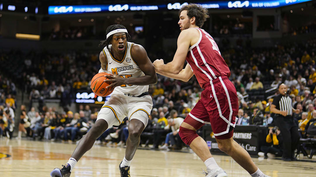 Feb 12, 2025; Columbia, Missouri, USA; Missouri Tigers guard Mark Mitchell (25) drives against Oklahoma Sooners forward Sam Godwin (10) during the first half at Mizzou Arena. Mandatory Credit: Jay Biggerstaff-Imagn Images
