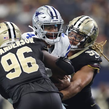 Sep 15, 2024; Arlington, Texas, USA; Dallas Cowboys quarterback Dak Prescott (4) is sacked by New Orleans Saints defensive end Carl Granderson (96) in the second half at AT&T Stadium. 