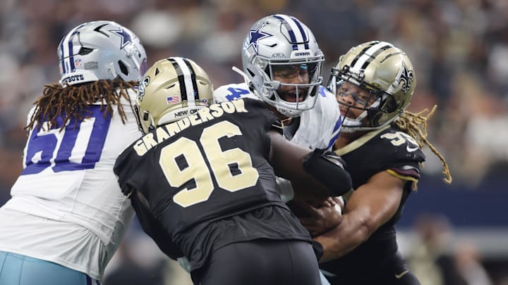 Sep 15, 2024; Arlington, Texas, USA; Dallas Cowboys quarterback Dak Prescott (4) is sacked by New Orleans Saints defensive end Carl Granderson (96) in the second half at AT&T Stadium. 