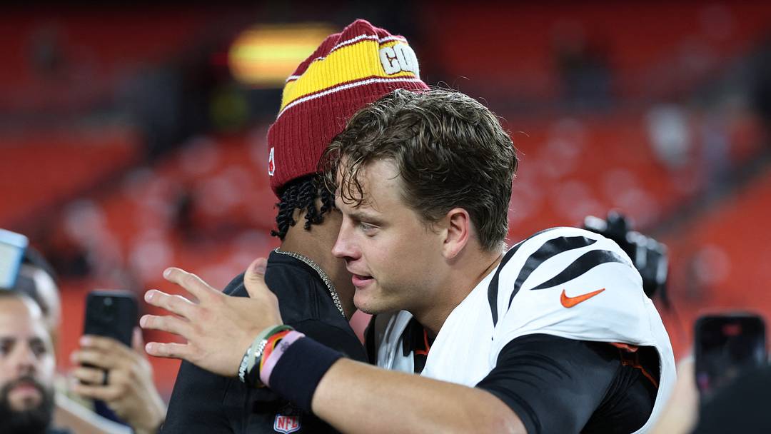 Aug 18, 2025; Landover, Maryland, USA; Cincinnati Bengals quarterback Joe Burrow (9) greets Washington Commanders quarterback Jayden Daniels (5) after their game at Northwest Stadium. Mandatory Credit: Amber Searls-Imagn Images