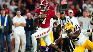 Nov 4, 2023; Tuscaloosa, Alabama, USA; Alabama Crimson Tide quarterback Jalen Milroe (4) scrambles up the field against LSU Tigers defensive end Saivion Jones (35) during the second half at Bryant-Denny Stadium. Alabama Crimson Tide defeated the LSU Tigers 42-28. Mandatory Credit: John David Mercer-Imagn Images
