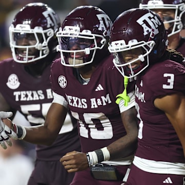 Texas A&M Aggies quarterback Marcel Reed (10) celebrates with wide receiver Ashton Bethel-Roman (3) after a play during the second half against the Louisiana State Tigers at Tiger Stadium.