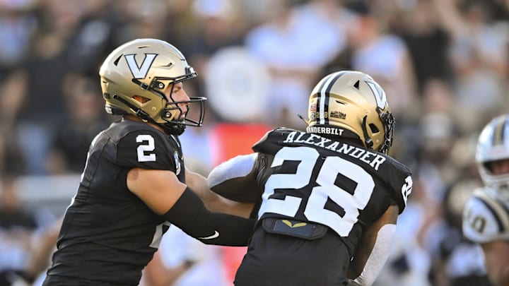 Aug 30, 2025; Nashville, Tennessee, USA;  Vanderbilt Commodores quarterback Diego Pavia (2) hands the ball off to running Sedrick Alexander (28) during the first half against the Charleston Southern Buccaneers at FirstBank Stadium. Mandatory Credit: Steve Roberts-Imagn Images