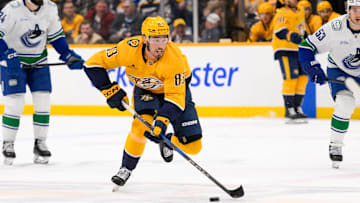 Jan 29, 2025; Nashville, Tennessee, USA;  Nashville Predators defenseman Adam Wilsby (83) skates with the puck against the Vancouver Canucks during the first period at Bridgestone Arena. Mandatory Credit: Steve Roberts-Imagn Images