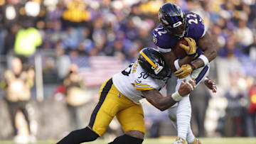 Dec 7, 2025; Baltimore, Maryland, USA; Pittsburgh Steelers linebacker Malik Harrison (50) tackles Baltimore Ravens running back Derrick Henry (22) during the first half at M&T Bank Stadium. Mandatory Credit: Peter Casey-Imagn Images
