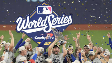 Nov 1, 2025; Toronto, Ontario, CAN; Los Angeles Dodgers pitcher Clayton Kershaw (22) celebrates with the Commissioner's Trophy after defeating the Toronto Blue Jays in game seven of the 2025 MLB World Series at Rogers Centre. Mandatory Credit: Kevin Sousa-Imagn Images