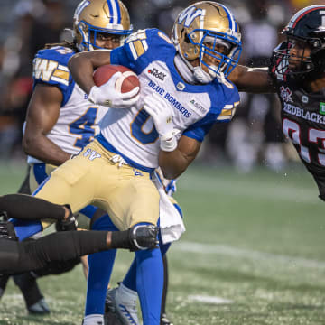 Jun 13, 2024; Ottawa, Ontario, CAN; Winnipeg Blue Bombers wide receiver Myron Mitchell (0) is tackled as he runs the ball in the first half against the Ottawa REDBLACKS at TD Place. Mandatory Credit: Marc DesRosiers-USA TODAY Sports