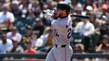 May 3, 2025; San Francisco, California, USA; Colorado Rockies third baseman Ryan McMahon (24) hits an RBI single against the San Francisco Giants during the sixth inning at Oracle Park. Mandatory Credit: Darren Yamashita-Imagn Images