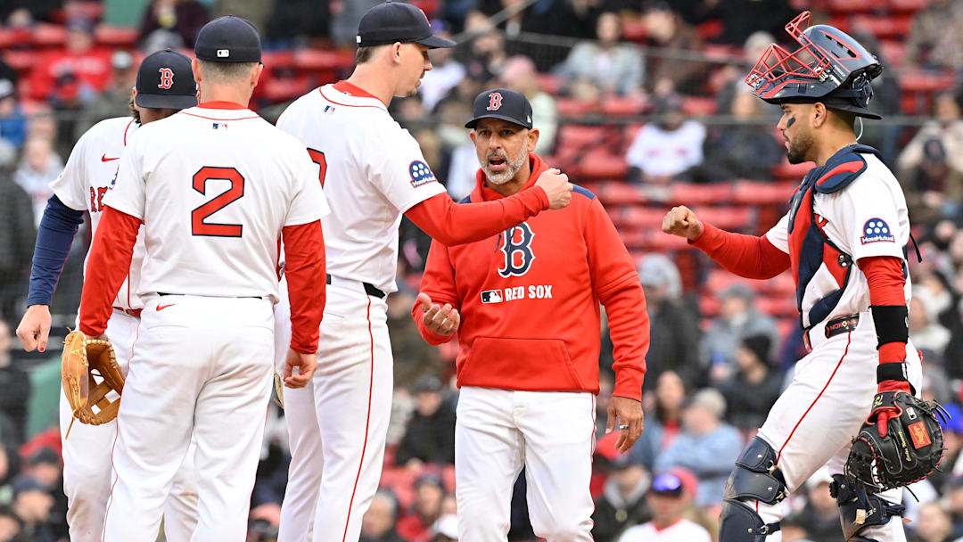 Boston Red Sox starting pitcher Walker Buehler (0) fist bumps catcher Carlos Narvaez (75) as manager Alex Cora (13) comes out to relieve him of the ball during the seventh inning against the Toronto Blue Jays at Fenway Park.