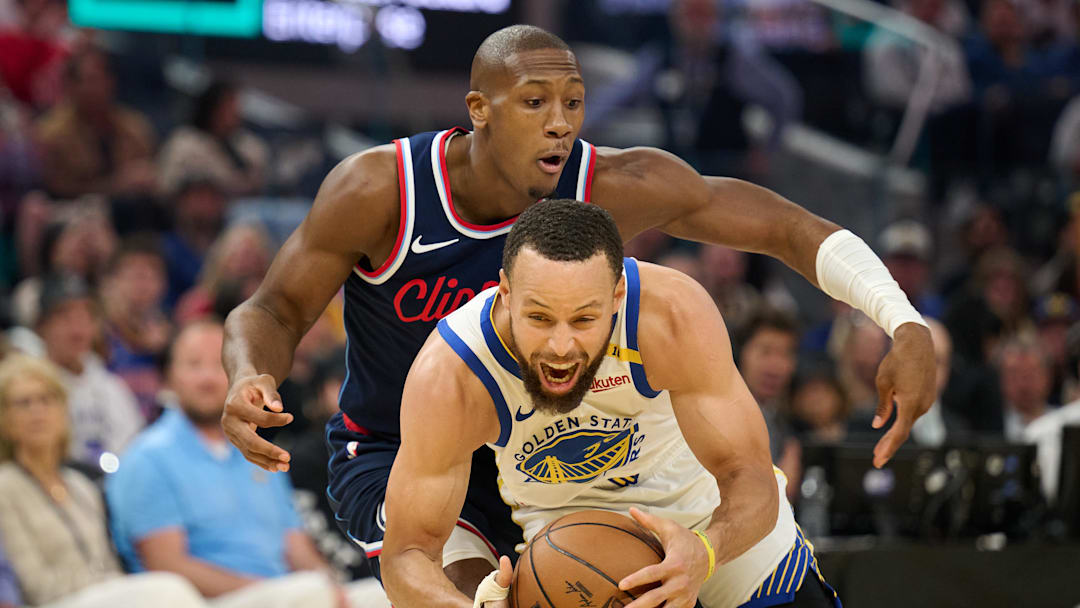 Apr 13, 2025; San Francisco, California, USA; Golden State Warriors guard Stephen Curry (30) reacts after a foul by LA Clippers guard Kris Dunn (8) during the first quarter at Chase Center. Mandatory Credit: Robert Edwards-Imagn Images