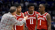 Arkansas Razorbacks head coach John Calipari talks with guard D.J. Wagner (21), forward Karter Knox (11), and guard Johnell Davis (1) against the Mississippi Rebels during the second half at Bridgestone Arena. 