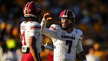 South Carolina football quarterback Spencer Rattler talking with receiver Tyshawn Russell after a dropped touchdown