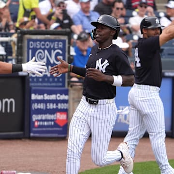 New York Yankees third base Jazz Chisholm Jr. is congratulated by shortstop Anthony Volpe.