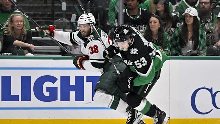 Apr 20, 2026; Dallas, Texas, USA; Minnesota Wild right wing Ryan Hartman (38) checks Dallas Stars center Wyatt Johnston (53) during the second period in game two of the first round of the 2026 Stanley Cup Playoffs at American Airlines Center. Mandatory Credit: Jerome Miron-Imagn Images