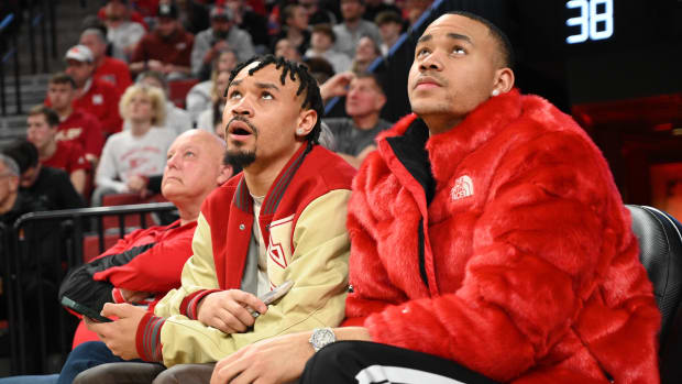 Former Nebraska Cornhuskers players Trey McGowens (left) and Bryce McGowens watch the game against the Maryland Terrapins.