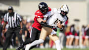 Oct 11, 2025; Cincinnati, Ohio, USA; Cincinnati Bearcats linebacker Jake Golday (11) attempts to tackle UCF Knights quarterback Cam Fancher (14) in the second half at Nippert Stadium. Mandatory Credit: Aaron Doster-Imagn Images