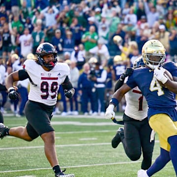 Sep 7, 2024; South Bend, Indiana, USA; Notre Dame Fighting Irish running back Jeremiyah Love (4) scores in the third quarter against the Northern Illinois Huskies at Notre Dame Stadium. Mandatory Credit: Matt Cashore-Imagn Images