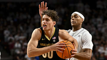 Feb 26, 2025; College Station, Texas, USA; Vanderbilt Commodores guard Chris Manon (30) drives past Texas A&M Aggies guard Zhuric Phelps (1) during the second half at Reed Arena. Mandatory Credit: Maria Lysaker-Imagn Images 