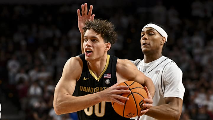 Feb 26, 2025; College Station, Texas, USA; Vanderbilt Commodores guard Chris Manon (30) drives past Texas A&M Aggies guard Zhuric Phelps (1) during the second half at Reed Arena. Mandatory Credit: Maria Lysaker-Imagn Images 